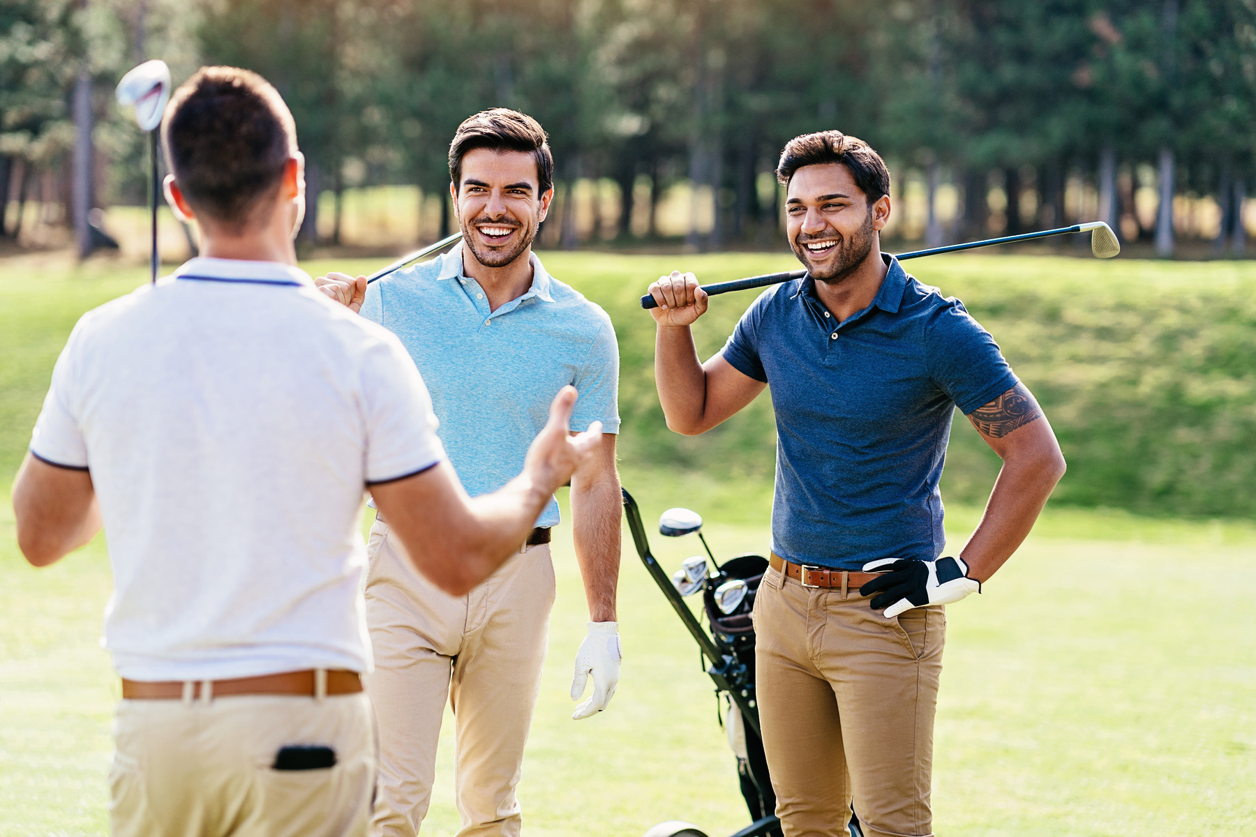 Male friends playing golf together